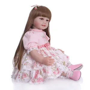 Lifelike 19-inch reborn doll girl with long brown hair in a pink floral princess dress