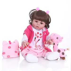 Lifelike 47cm silicone reborn baby doll girl with brown hair, pink outfit and giraffe toy