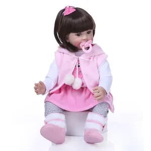 Reborn toddler princess doll in pink plush outfit with long hair and pacifier