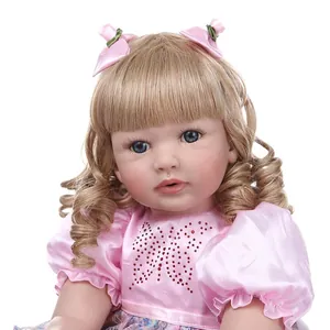 60cm Reborn toddler doll with long blonde hair and pink satin dress with bow detail
