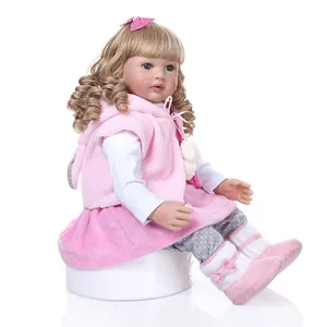 Lifelike reborn toddler doll with long blonde hair in a pink plush vest and skirt outfit