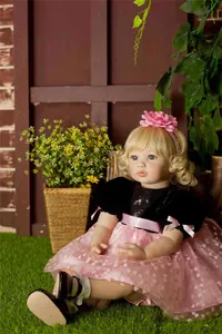 Detailed view of 60cm reborn toddler doll with blonde hair in a pink mesh princess dress