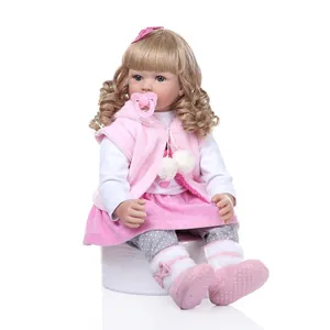 Reborn toddler princess doll with long blonde hair in pink plush outfit and pacifier