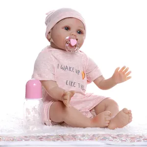 Poupée bébé reborn réaliste en tenue rayée rose avec une tétine et un biberon