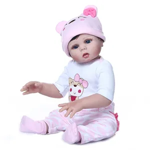 Realistic 47cm newborn baby doll in pink bear outfit with hat and socks, sitting view