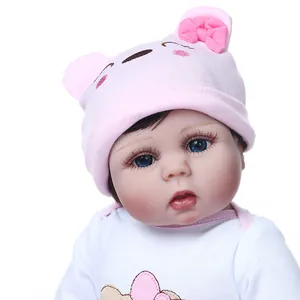 Realistic 47cm baby doll with blue eyes and pink bear hat on a clean white background