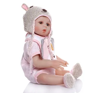 Detailed macro shot of a realistic reborn baby doll in pink striped pajamas and bunny hat
