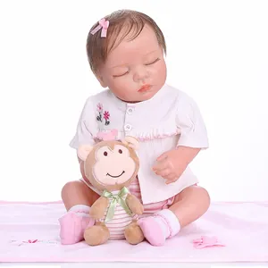Lifelike full silicone reborn baby doll in pink stripe outfit with plush toy and pacifier