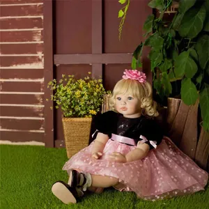 60cm reborn toddler doll with blonde hair and pink tutu dress in garden setting