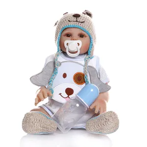 Detailed full-body view of a lifelike reborn baby doll with accessories and blue outfit