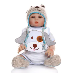Realistic reborn baby doll set featuring a dog-themed knit hat and matching blue booties