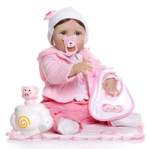 Realistic reborn baby doll with blue eyes and pink outfit set with accessories