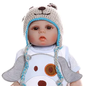 Detail of reborn doll wearing a handmade bear-shaped knitted hat with realistic facial features