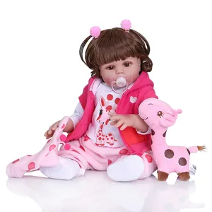 Detailed view of reborn baby doll in pink giraffe outfit with matching plush toy