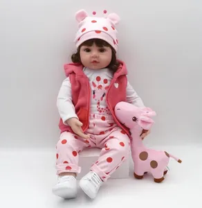 Close-up of realistic reborn doll wearing pink polka dot outfit and giraffe shirt