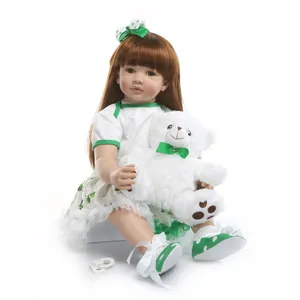 Realistic reborn toddler doll with green clover dress, brown hair and teddy bear