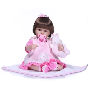 Realistic silicone baby doll with pink floral headband, kitty outfit and plush rabbit toy