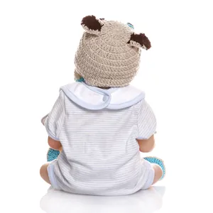 Detail of baby doll wearing a blue striped onesie and a knit bear hat from behind