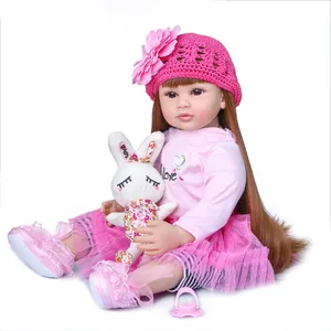 Realistic reborn toddler doll with long brown hair, pink tutu outfit and plush bunny accessory