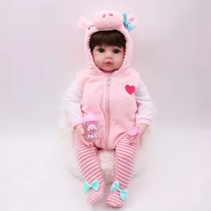Realistic reborn baby doll in pink piglet hoodie outfit with bottle and pacifier accessories
