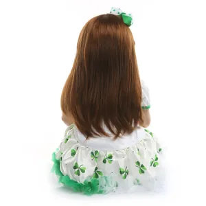 Realistic reborn toddler doll with long brown hair in a St. Patrick's clover tutu dress