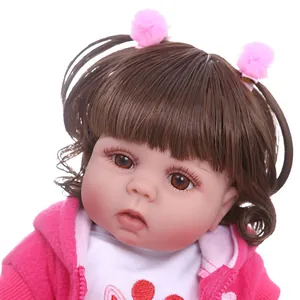 Lifelike reborn baby doll in pink fleece hoodie with brown hair and floral embroidery