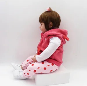 Lifelike 47cm reborn baby doll wearing a pink fleece vest and polka dot pants