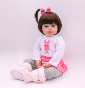 Detailed view of a 47cm lifelike reborn toddler doll with brown hair and pink bunny outfit
