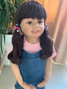 Detail of 98cm realistic girl doll with brown pigtails and denim dungaree outfit