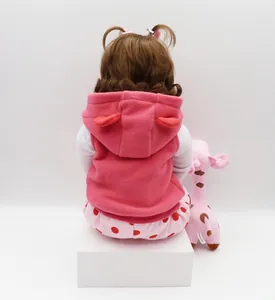 Rear view of 47cm soft silicone reborn baby doll wearing a pink fleece hooded vest