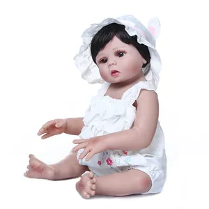 Lifelike 47cm full silicone reborn baby doll wearing white lace outfit with floral embroidery