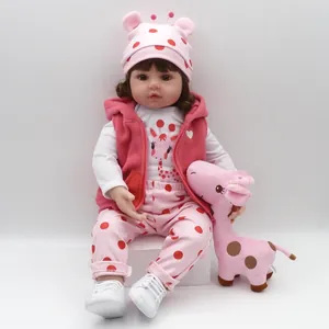 Lifelike 47cm reborn baby doll in pink polka dot outfit with a giraffe plush toy
