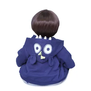 Detail of 60cm reborn toddler doll wearing a navy hoodie with owl embroidery and white crest