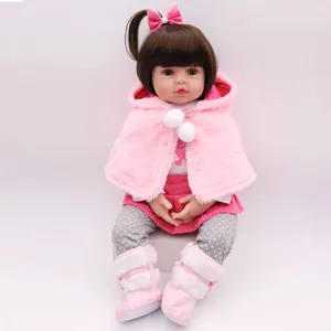 Lifelike 47cm reborn baby doll wearing a pink plush hooded cloak and matching soft boots