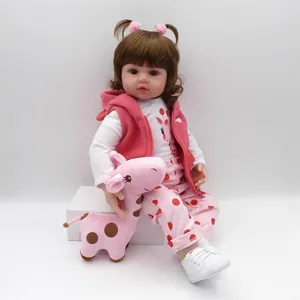 Lifelike 47cm reborn baby doll with brown curls, pink giraffe outfit and plush toy