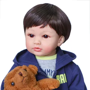 60cm realistic reborn boy doll with brown hair in blue hoodie holding a teddy bear