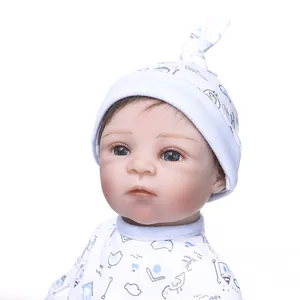 Detailed close-up of 30cm realistic baby doll with lifelike facial features and blue cap