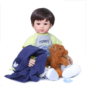 Realistic 60cm reborn toddler boy doll with brown hair, blue jacket and teddy bear