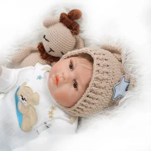 Bambola reborn realistica con pagliaccetto bianco e cappello di lana su morbida pelliccia