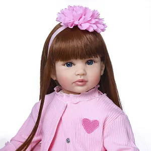 60cm reborn doll with brown long hair and pink striped outfit on white background