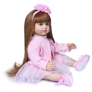 Realistic 60cm reborn toddler doll with long brown hair in a pink striped cardigan and tutu