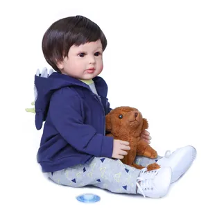 Detailed view of a 60cm reborn toddler boy doll with brown hair and blue hoodie