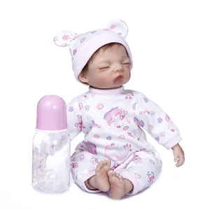 Detailed view of a 30cm sleeping reborn baby doll with pink outfit and matching bottle