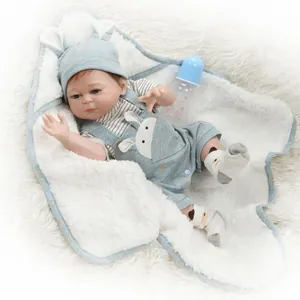 Close-up of 48CM reborn doll with rabbit outfit and blue bottle on white fur rug