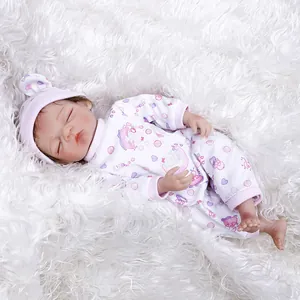 30cm realistic sleeping baby doll with brown hair and colorful patterned romper