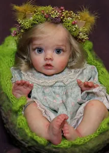 Close-up of reborn doll with blue eyes and blonde curls wearing a floral lace dress