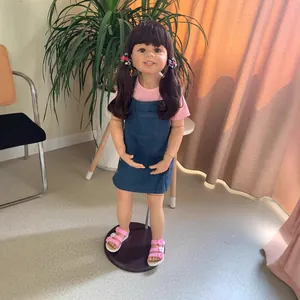 Lifelike 98cm girl doll with brown pigtails in denim dress on a standing base