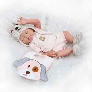 Detail of 48cm lifelike silicone reborn doll in pink outfit with pacifier and bib