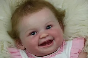 Close-up of lifelike 22-inch reborn doll kit with blonde hair and blue eyes