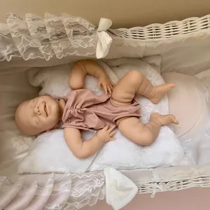 Reborn doll kit April featuring a smiling sleeping baby in a pink bodysuit